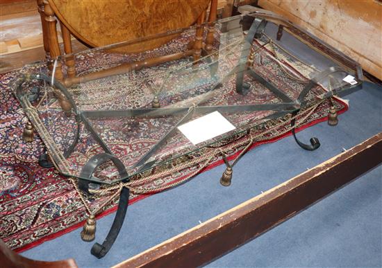 A glass top wrought iron coffee table L.122cm